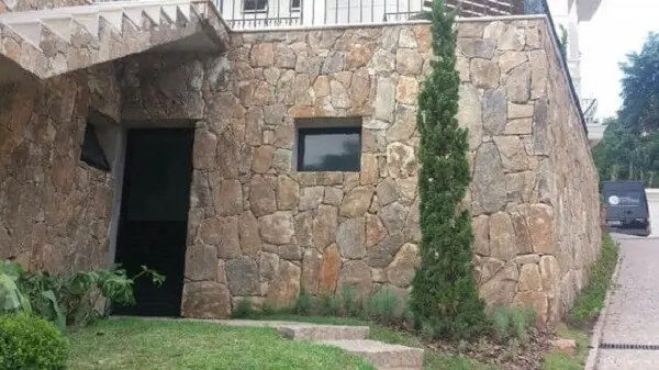 Fachada de muro com pedras bolão