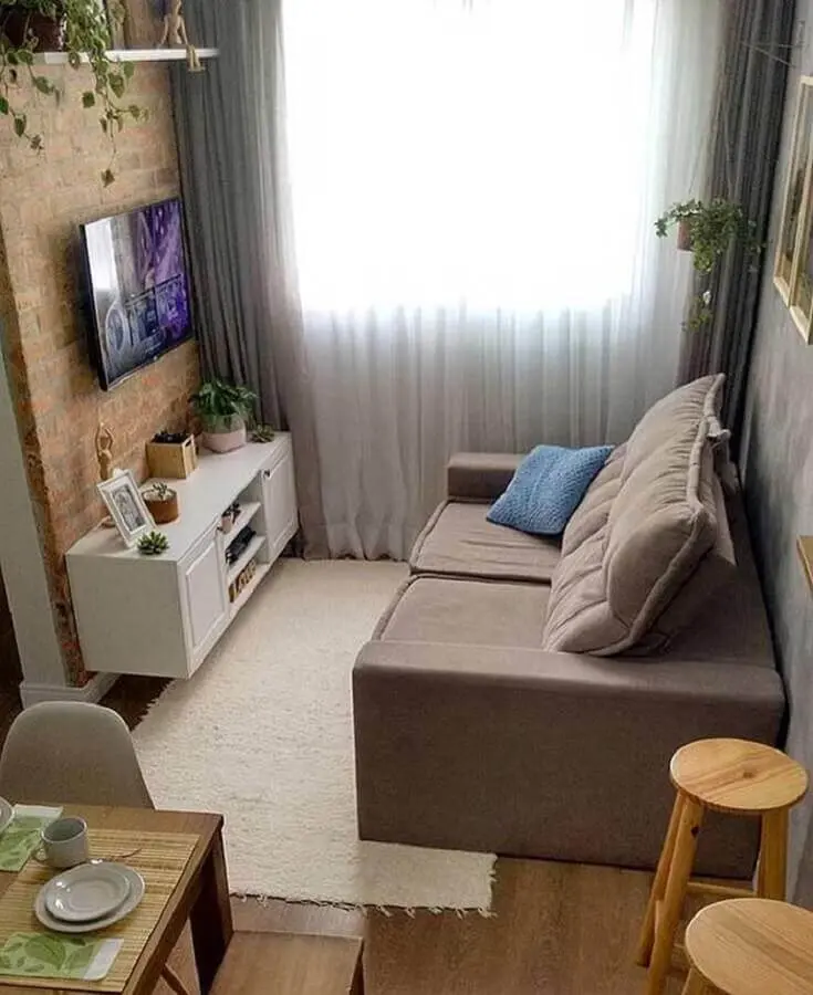 sofá pequeno para sala de TV decorada com parede tijolinho Foto Histórias de Casa