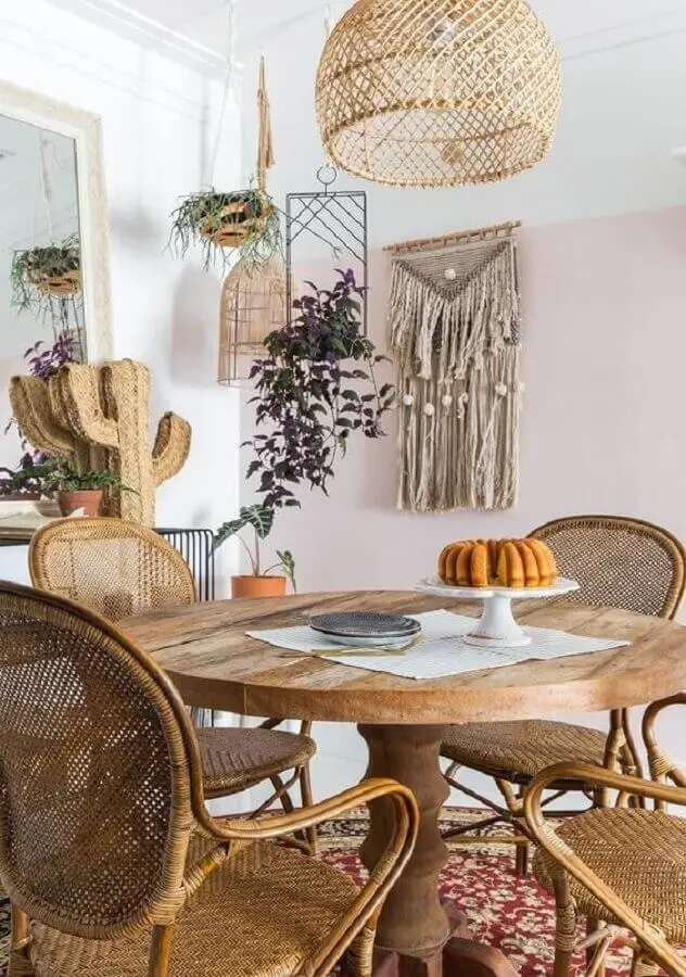 decoração sala de jantar com mesa redonda de madeira e luminária rústica de teto Foto Histórias de Casa