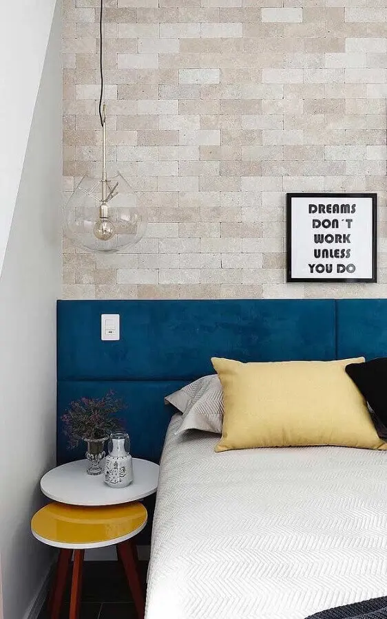 quarto decorado com parede de tijolinho e cabeceira estofada na cor azul petróleo Foto Maurício Gebara Arquitetura