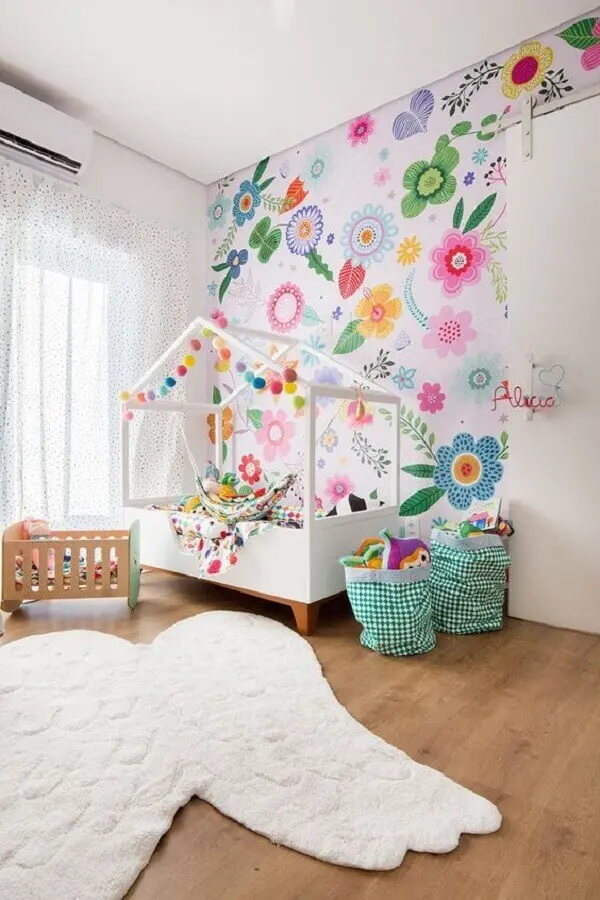 quarto para criança decorado com papel de parede floral colorido e cama casinha Foto MOOUI