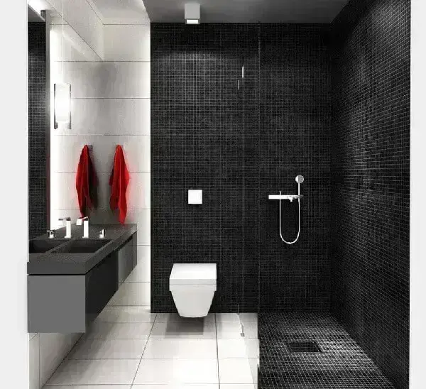 A pastilha preta fosca marca presença no revestimento de parede e piso desse banheiro