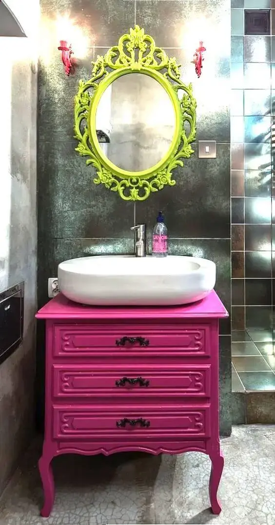 Banheiro com gabinete pink e espelho com moldura colorida verde limao