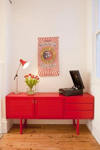  Casa com aparador retro vermelho e vitrola na decoração 