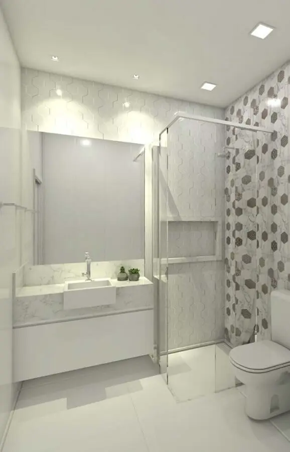 bancada de mármore branco para banheiro decorado com revestimento geométrico