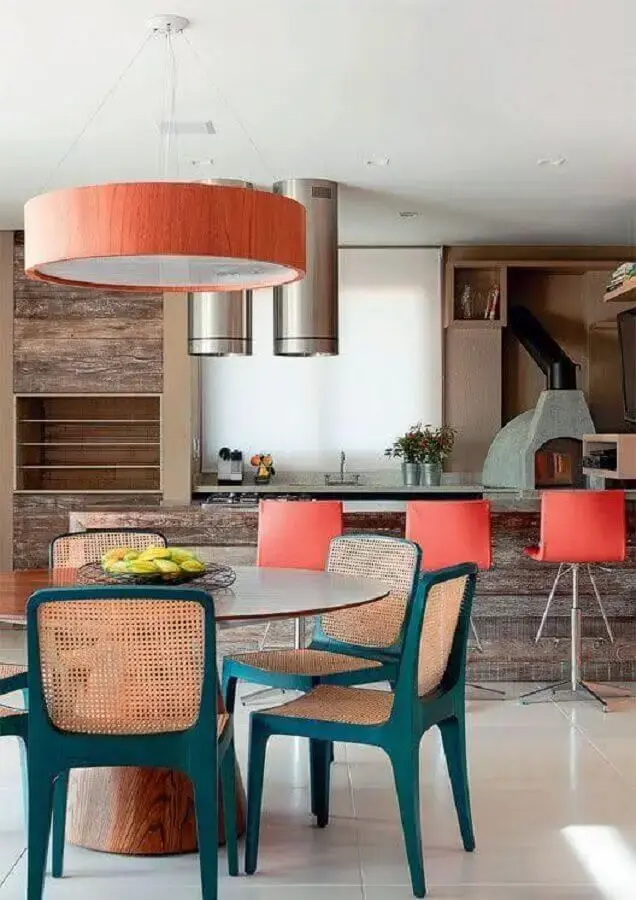 decoração de varanda gourmet com cadeiras coloridas para mesa de jantar redonda Foto Histórias de Casa