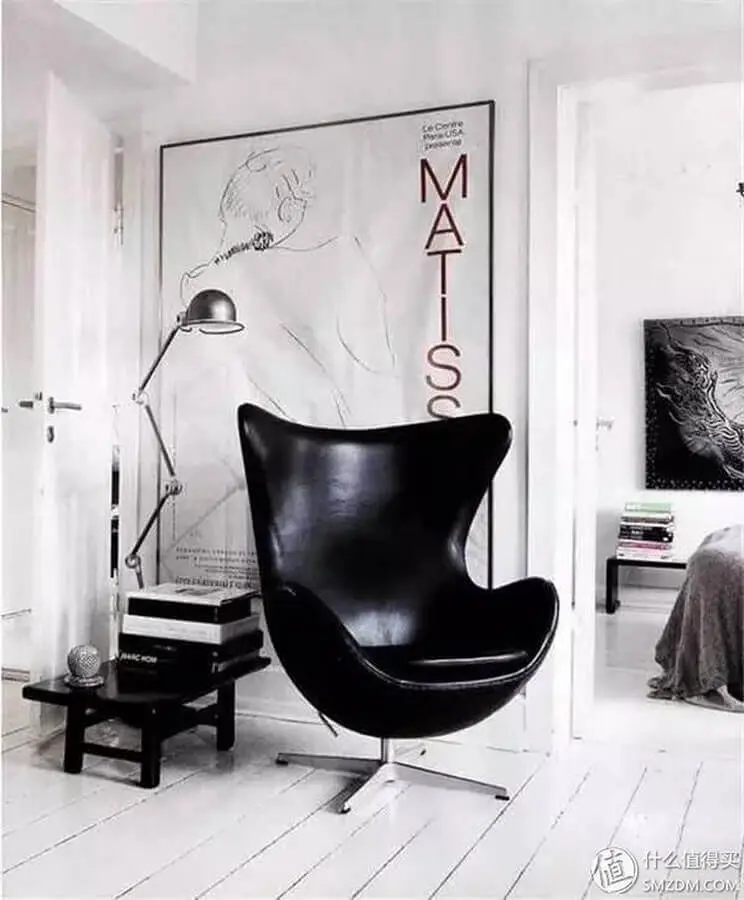 Sala branca com estilo minimalista decorada com poltrona giratória preta