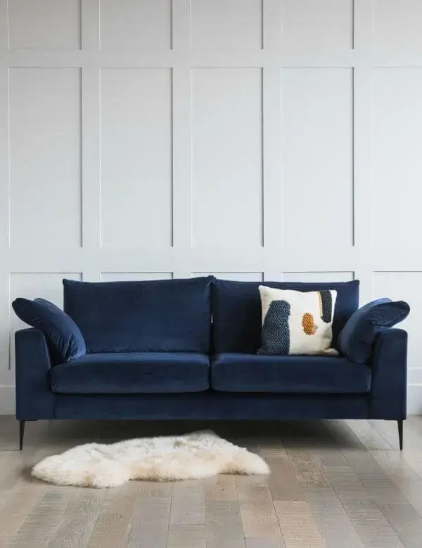 Sala Branca com sofá azul marinho e almofada