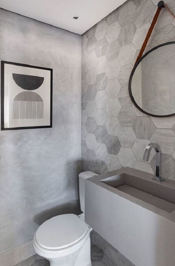 banheiro cimento queimado decorado com revestimento hexagonal e espelho redondo Foto Pinterest
