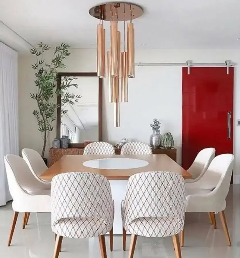 cadeira de jantar estofada para sala decorada com mesa quadrada e luminária pendente rose gold Foto Pinterest