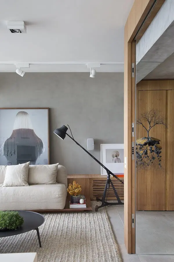 decoração moderna com parede de cimento queimado e luminárias de piso para sala de estar Foto Studio Roca