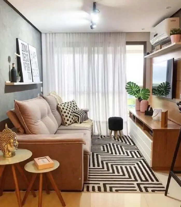 sofá para sala de apartamento decorado com tapete geométrico e rack de madeira Foto Jeito de Casa