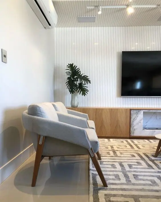Poltronas para sala de espera com tv e decoração moderna