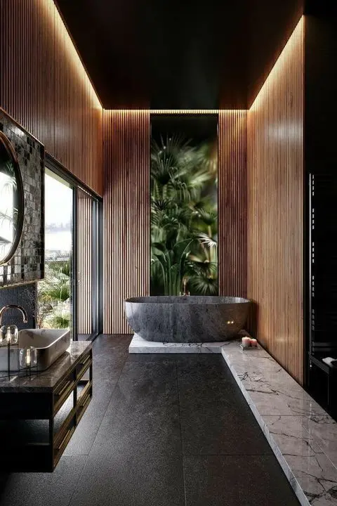 Banheiro com piso de ardósia preta e banheira cinza