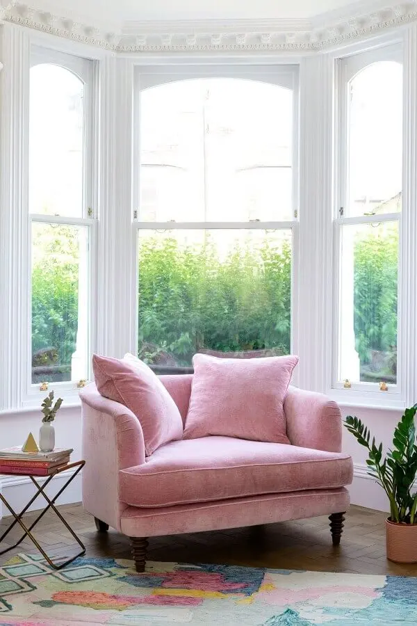 Cantinho de leitura decorado com poltrona confortável rosa Foto Fashionismo