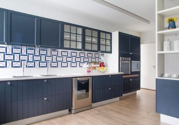 Cozinha azul com bancada de quartzo e revestimento geométrico