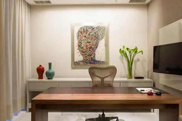 Decoração clean com quadro decorativo colorido para escritório pequeno. Projeto de Marília Veiga