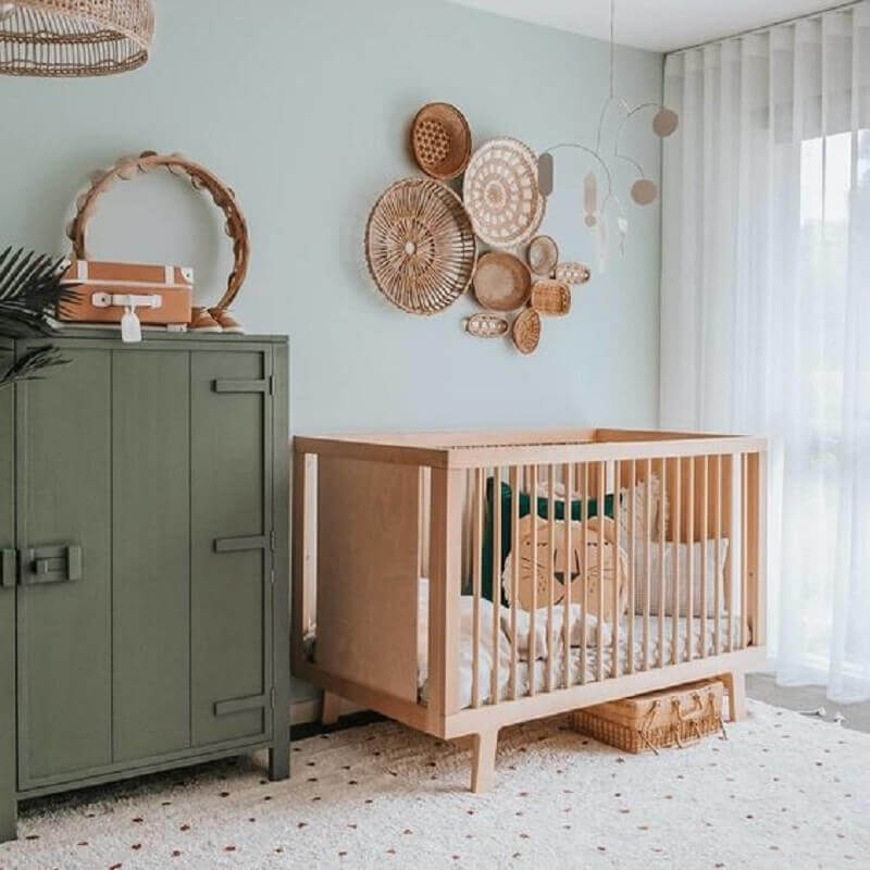 Berço de bebê de madeira para quarto simples decorado com parede azul claro e armário antigo Foto DecoIdeas