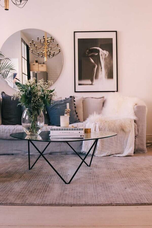 Espelho redondo na sala de estar decorada com sofá cinza e mesa de centro de vidro Foto Decor Fácil