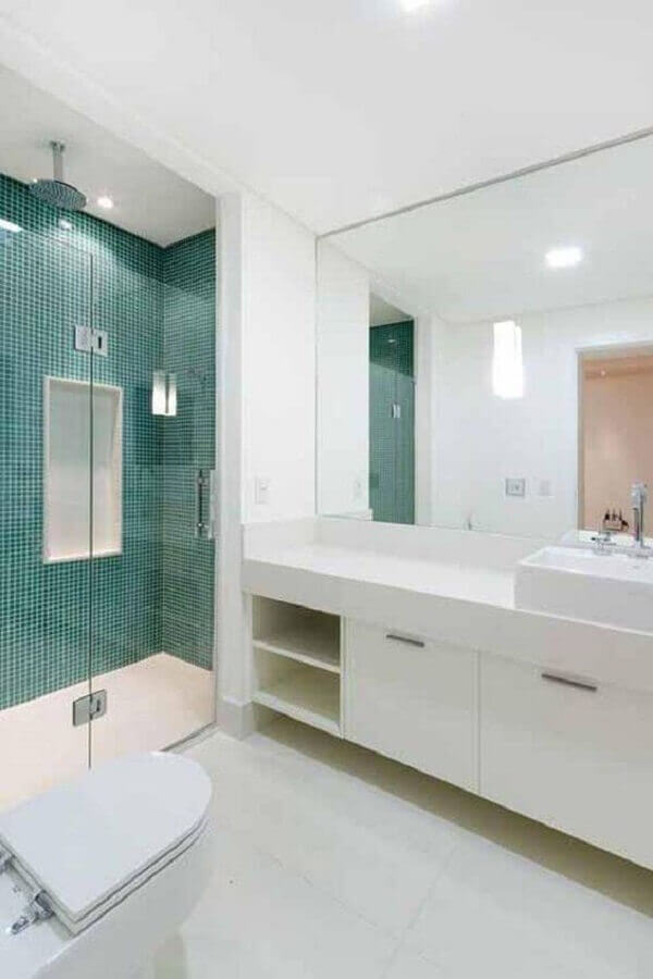 Gabinete branco para banheiro grande decorado com pastilhas verdes na area do box Foto Camila Tannous