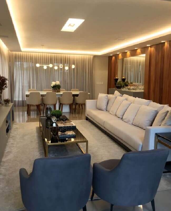 Iluminação sala de estar e jantar integradas decoradas com parede de madeira Foto Fernanda Barros Arquitetura