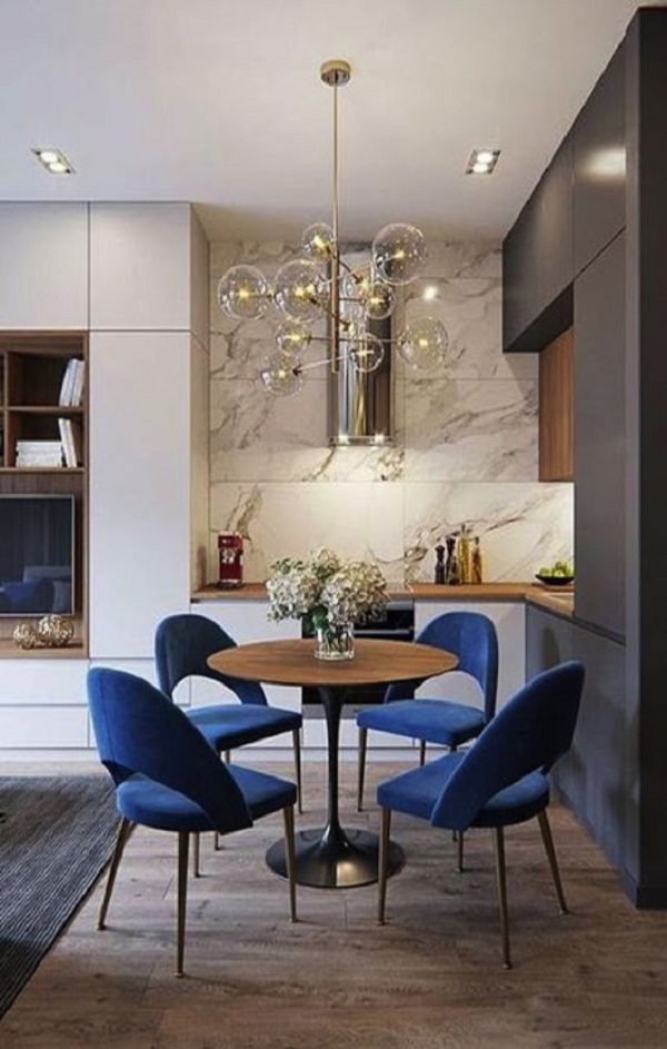 Cozinha pequena com mesa iluminada por luminária redonda estilo retrô 