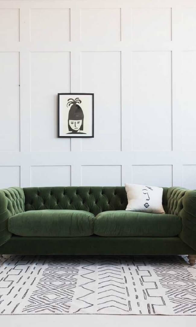 O sofá capitonê verde rouba a cena nessa sala de estar