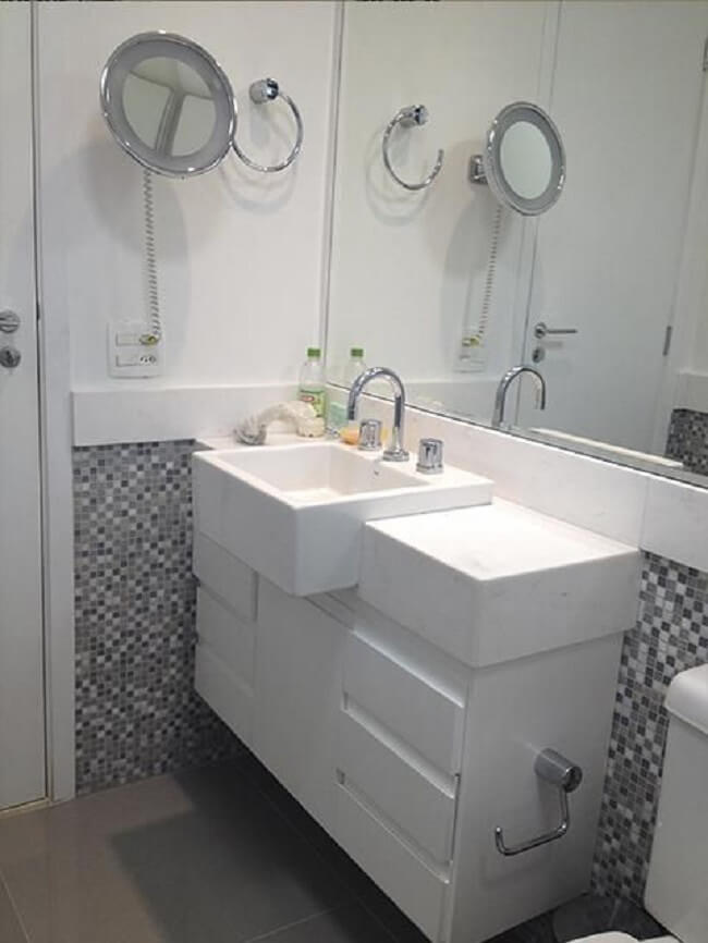 Modelo de gabinete para banheiro pequeno com cuba branca e pastilhas na parede. Fonte: Andreza Baroni