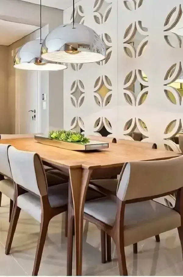 Lustre pendente com acabamento metálico e arranjo de flores para mesa de jantar. Fonte: Conexão Décor