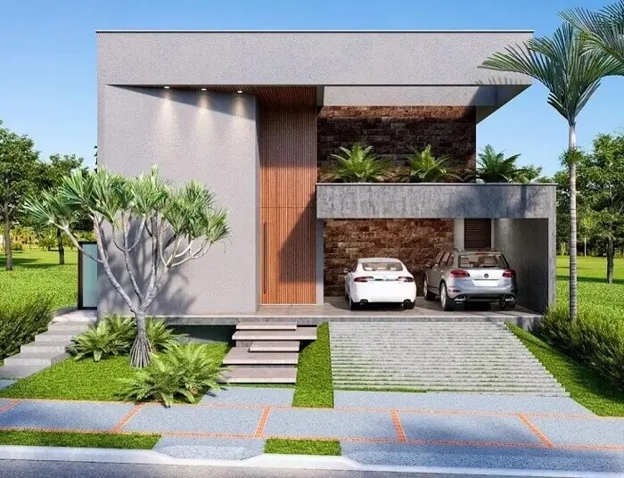 Casa com fachada cinza e garagem lateral com rampa para dois carros