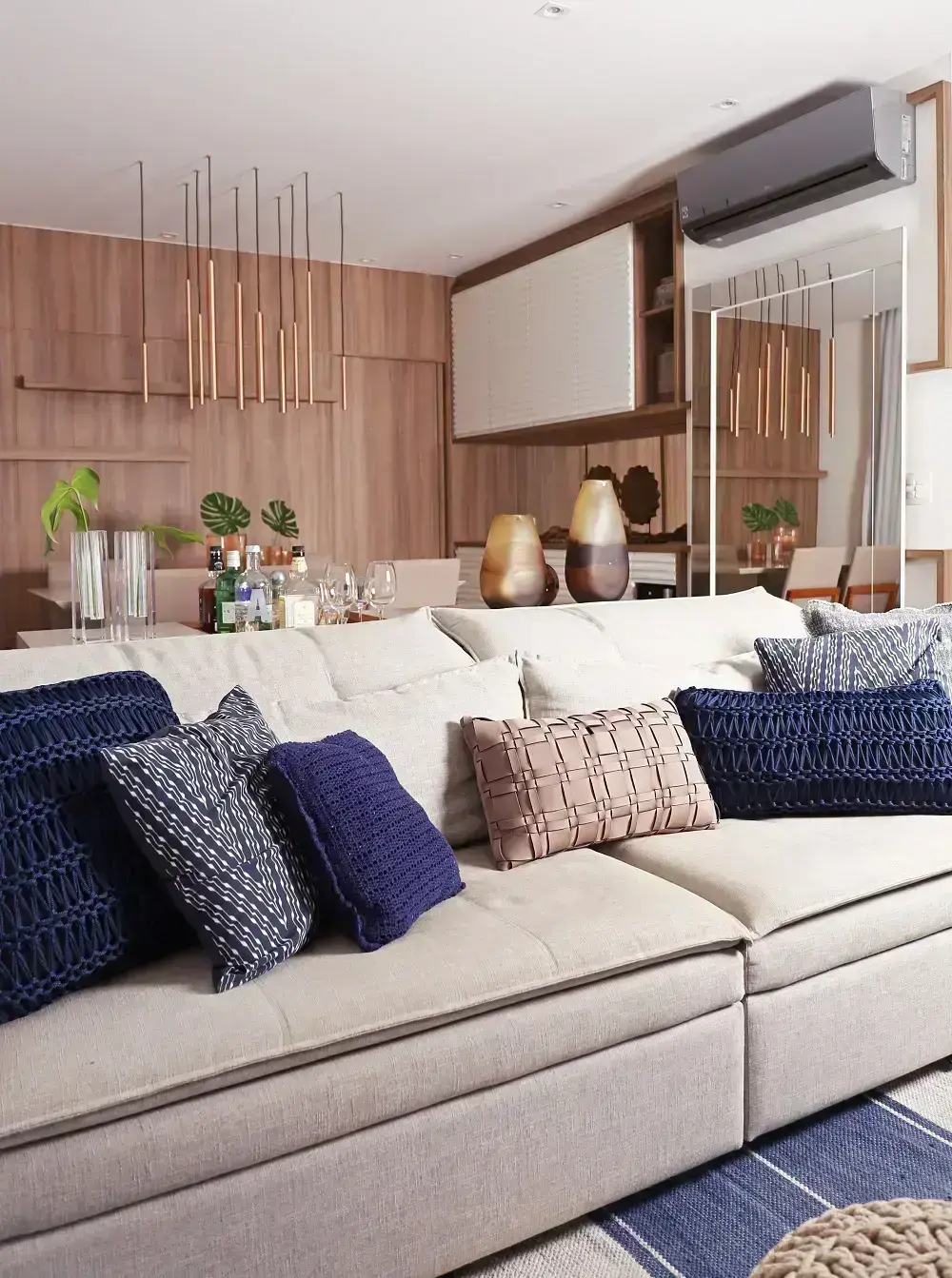 Sala de estar com sofá em L com um mix de almofadas soltas