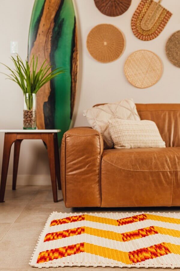 Tapete geométrico de crochê para decorar ambiente com sofá de couro marrom Foto Círculo
