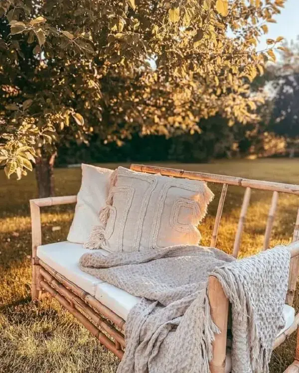 A manta e as almofadas trazem mais conforto ao sofá de bambu