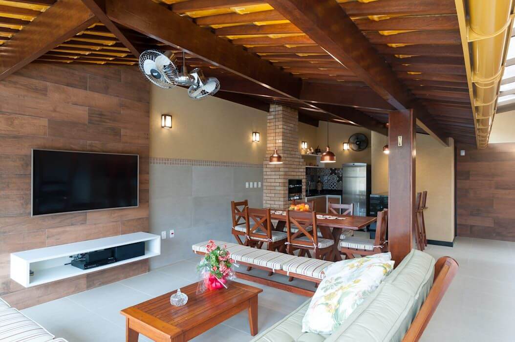 Área de churrasqueira e móveis confortáveis na decoração de ambientes externos