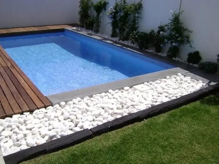 A pedra para jardim branca realça a cor da piscina