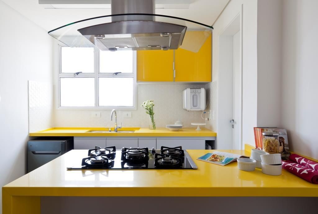 Cozinha com armário pequeno de parede na cor amarela combinando com a bancada