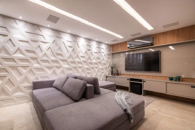 Sala com revestimento 3D e sofá ilha